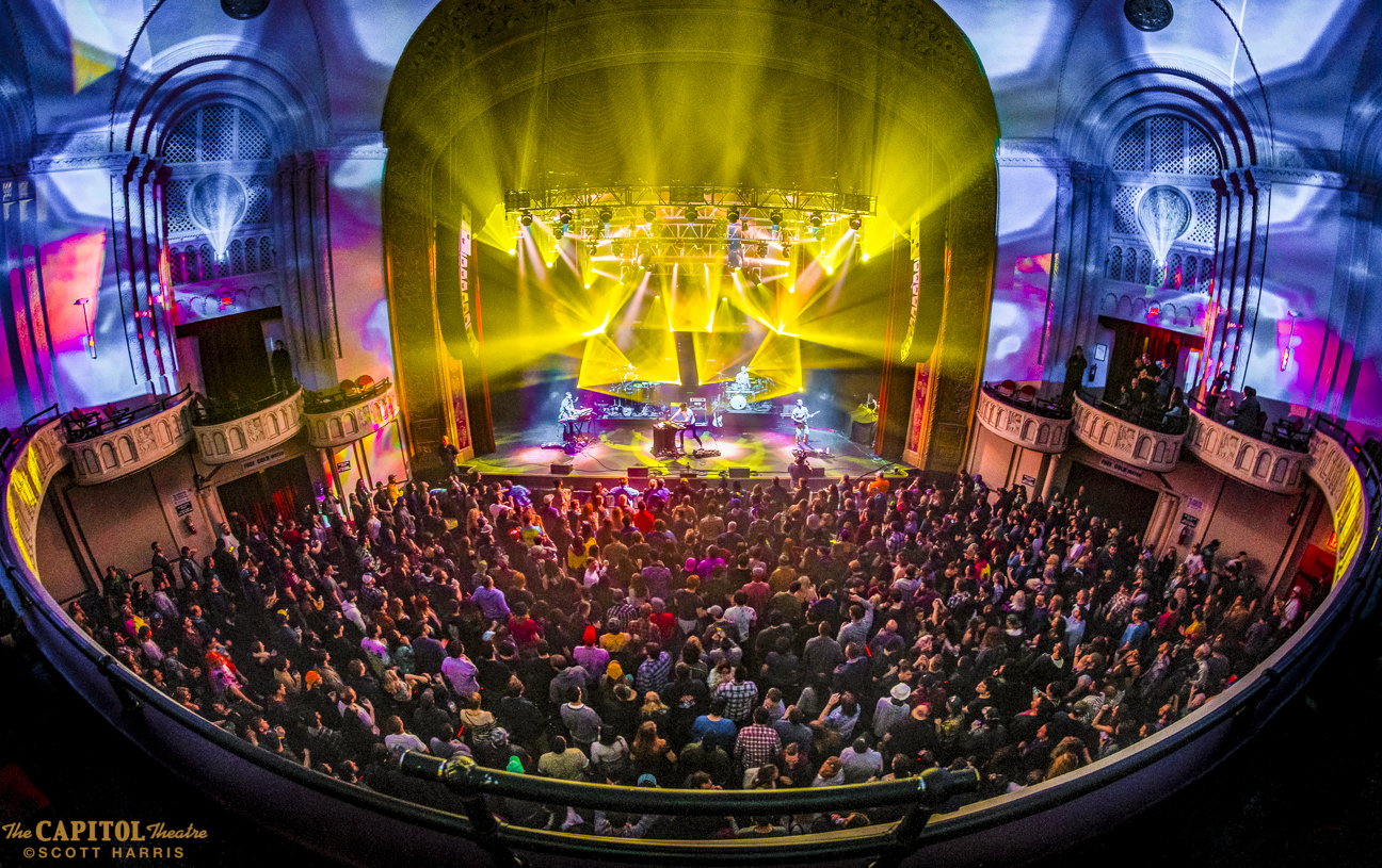 Yellow lights shimmer with a packed concert at The Capitol Theatre